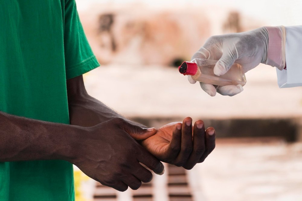 Feature Image of the projects page -- showing a hand receiving medication from a medical practitioner